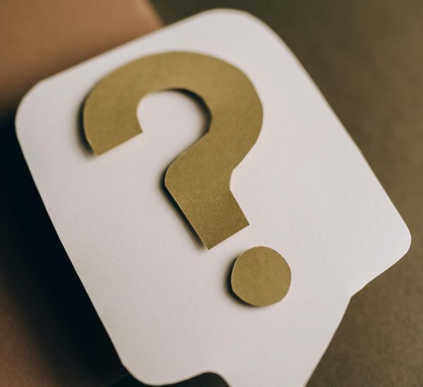 Artistic paper craft of a question mark symbol on a textured green surface. Ideal for conceptual projects.